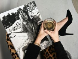 woman holding clear glass candle holder and grayscale portrait of a woman